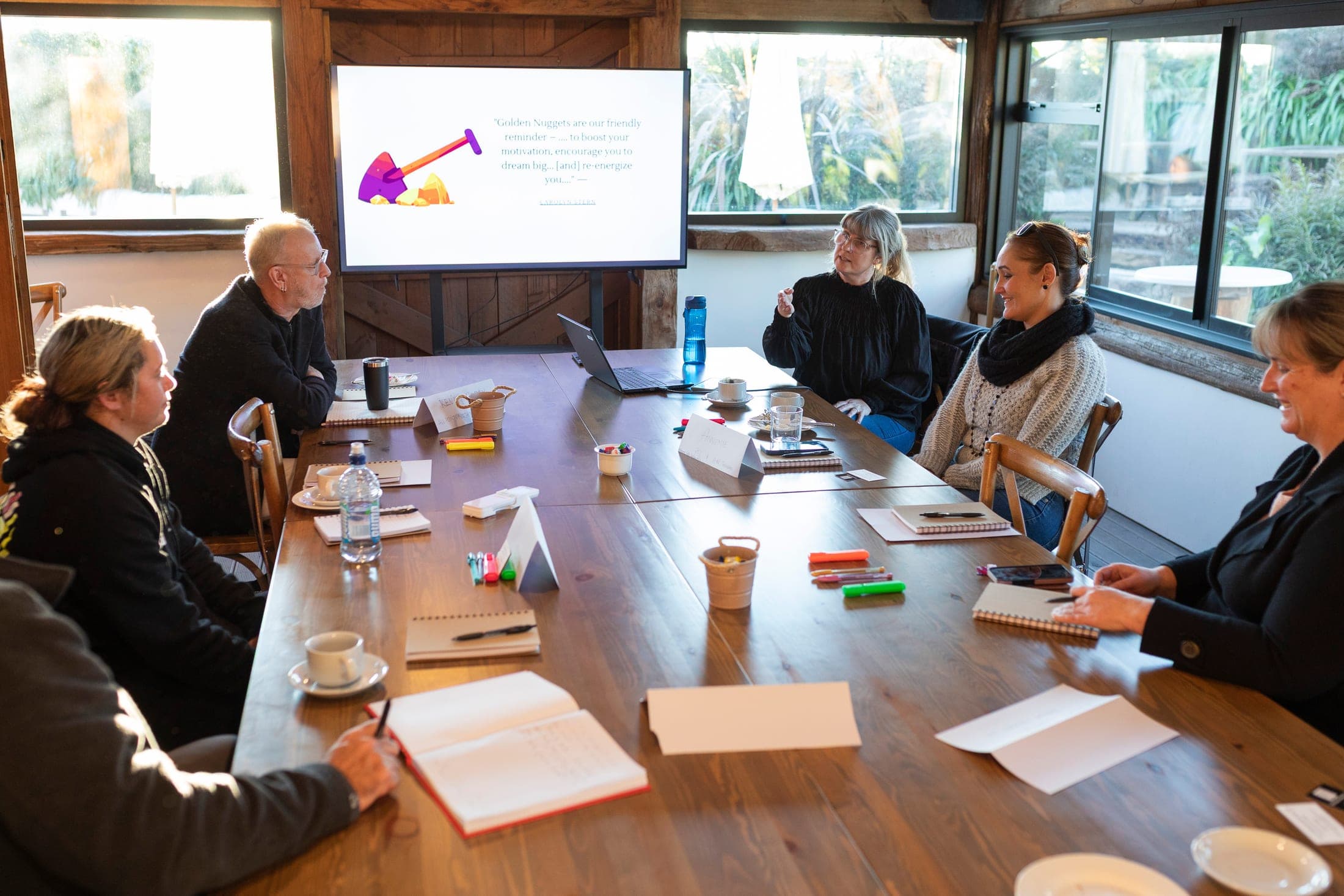 Business owners around a table with Mel Curwood at one of her cash flow workshops